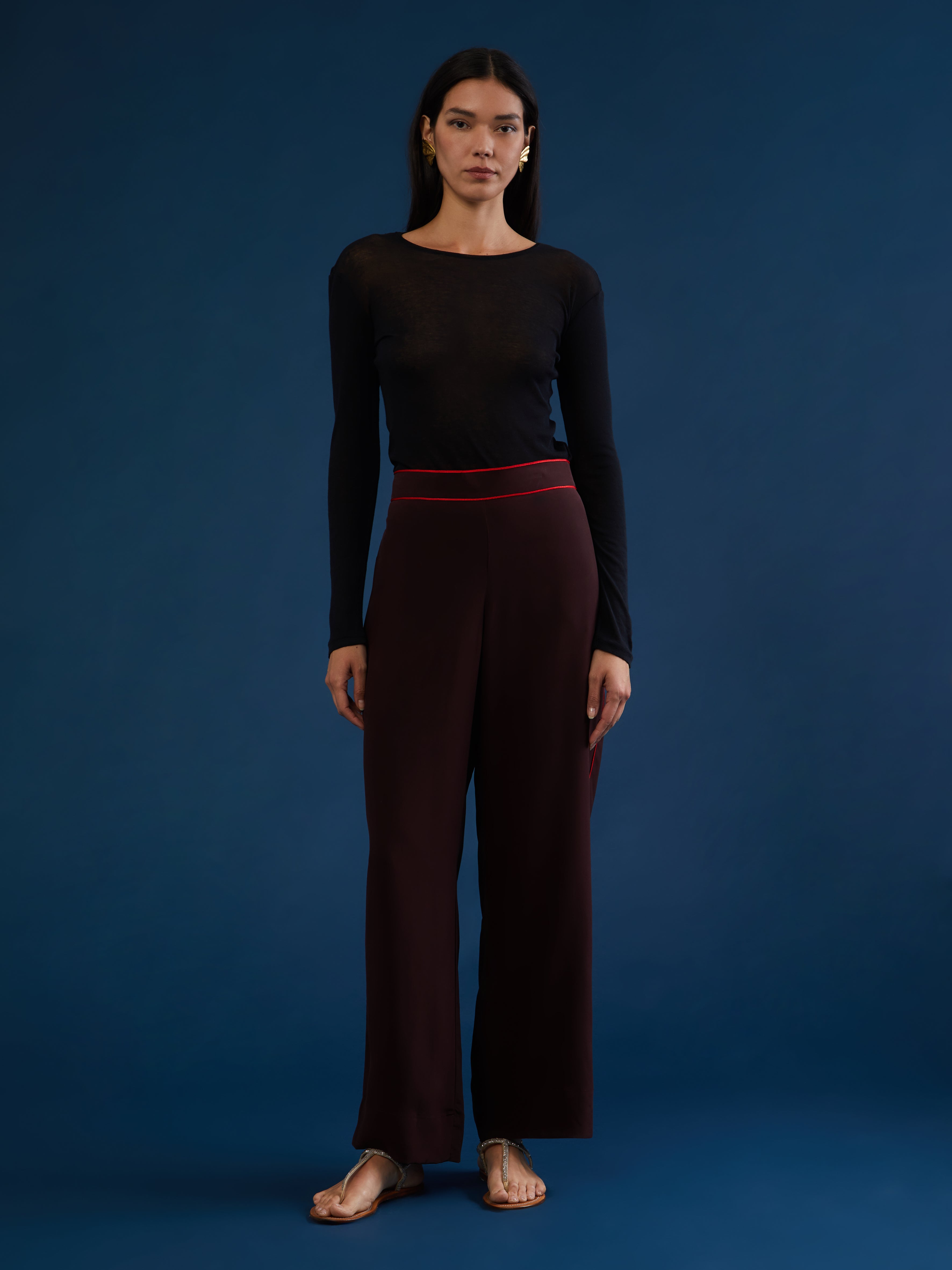 The pants are part of a chic and lightweight silk set crafted in Morocco featuring exquisite Italian silk fabrics. Designed for ultimate comfort and style, this set exudes effortless elegance with its relaxed fit. Each piece is meticulously detailed with Moroccan embroidery, adding a touch of artisanal craftsmanship to the ensemble. The wide-legs offer style and comfort, and its elasticated waist ensures an adjustable fit. DETAILS AND CARE Red with purple details 100% silk Elasticated waist Dry clean only M