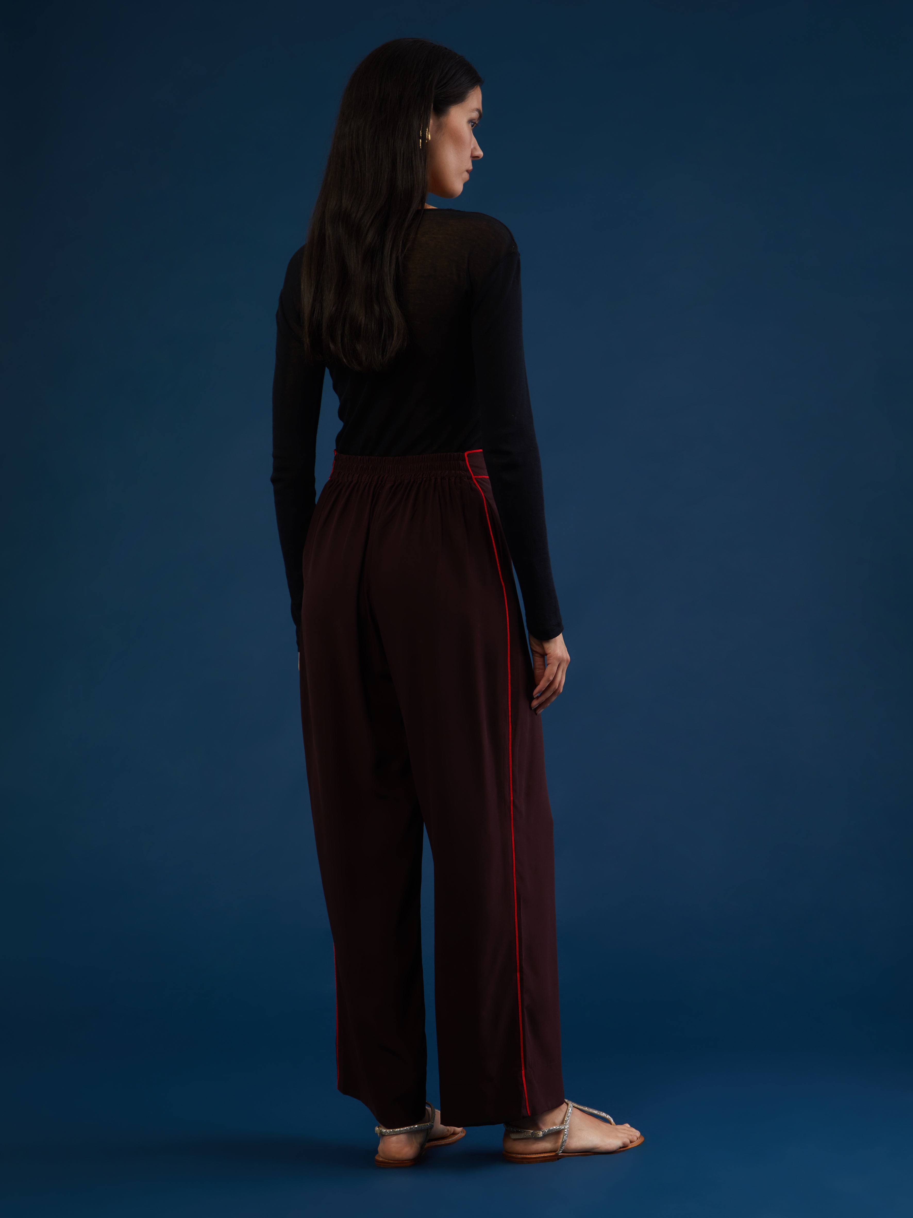 The pants are part of a chic and lightweight silk set crafted in Morocco featuring exquisite Italian silk fabrics. Designed for ultimate comfort and style, this set exudes effortless elegance with its relaxed fit. Each piece is meticulously detailed with Moroccan embroidery, adding a touch of artisanal craftsmanship to the ensemble. The wide-legs offer style and comfort, and its elasticated waist ensures an adjustable fit. DETAILS AND CARE Red with purple details 100% silk Elasticated waist Dry clean only M