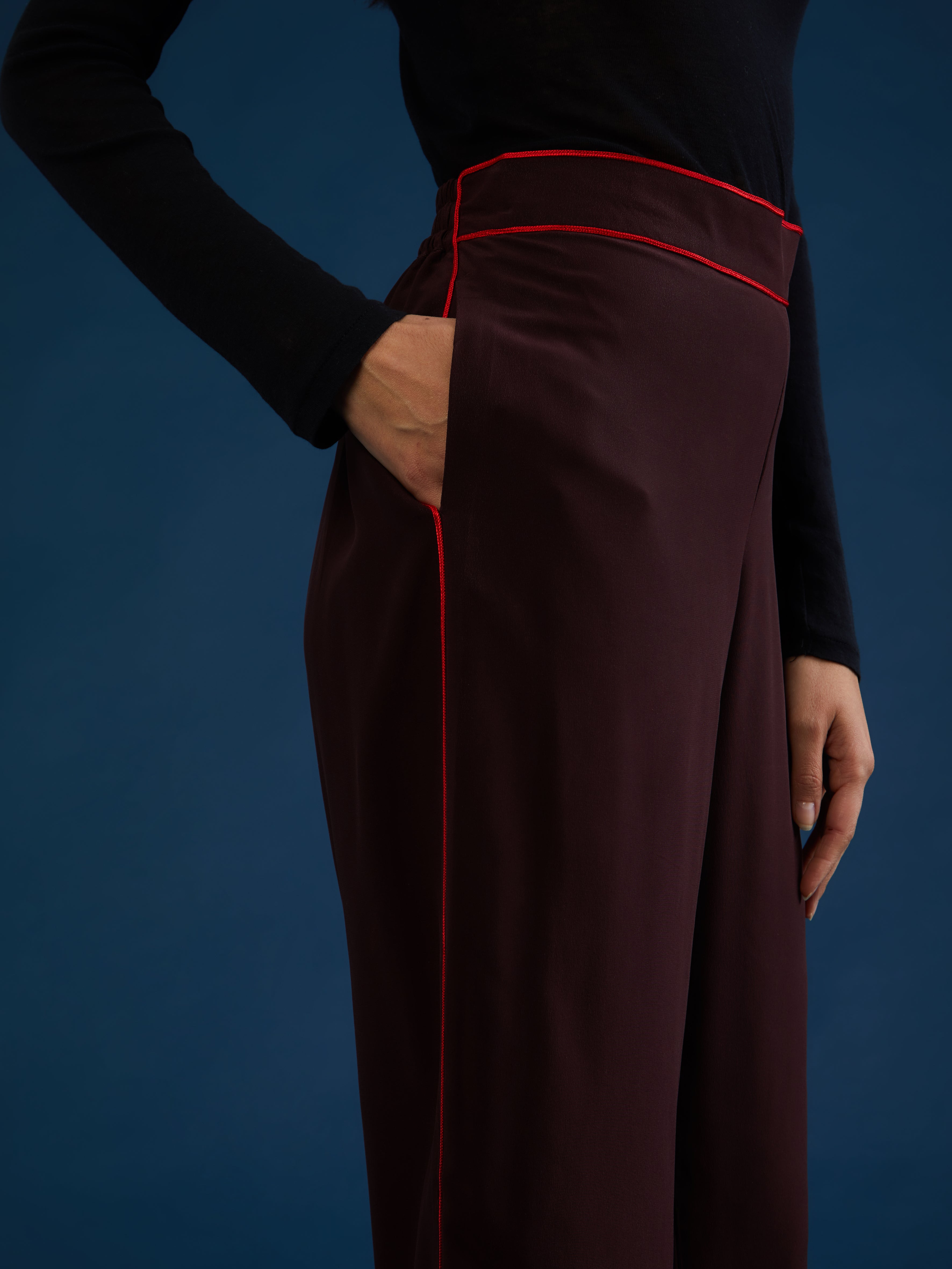 The pants are part of a chic and lightweight silk set crafted in Morocco featuring exquisite Italian silk fabrics. Designed for ultimate comfort and style, this set exudes effortless elegance with its relaxed fit. Each piece is meticulously detailed with Moroccan embroidery, adding a touch of artisanal craftsmanship to the ensemble. The wide-legs offer style and comfort, and its elasticated waist ensures an adjustable fit. DETAILS AND CARE Red with purple details 100% silk Elasticated waist Dry clean only M