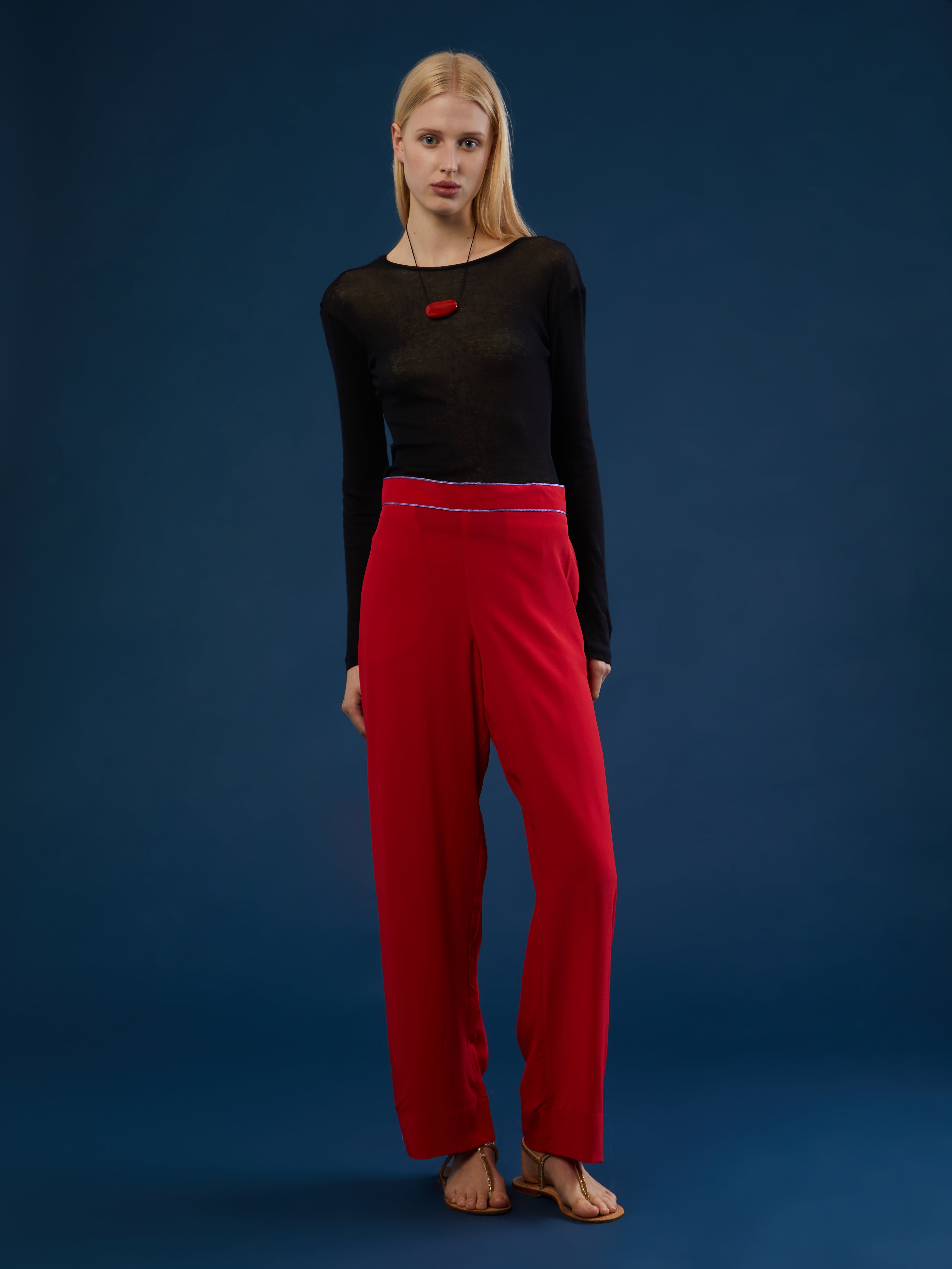 The pants are part of a chic and lightweight silk set crafted in Morocco featuring exquisite Italian silk fabrics. Designed for ultimate comfort and style, this set exudes effortless elegance with its relaxed fit. Each piece is meticulously detailed with Moroccan embroidery, adding a touch of artisanal craftsmanship to the ensemble. The wide-legs offer style and comfort, and its elasticated waist ensures an adjustable fit. DETAILS AND CARE Red with purple details 100% silk Elasticated waist Dry clean only M