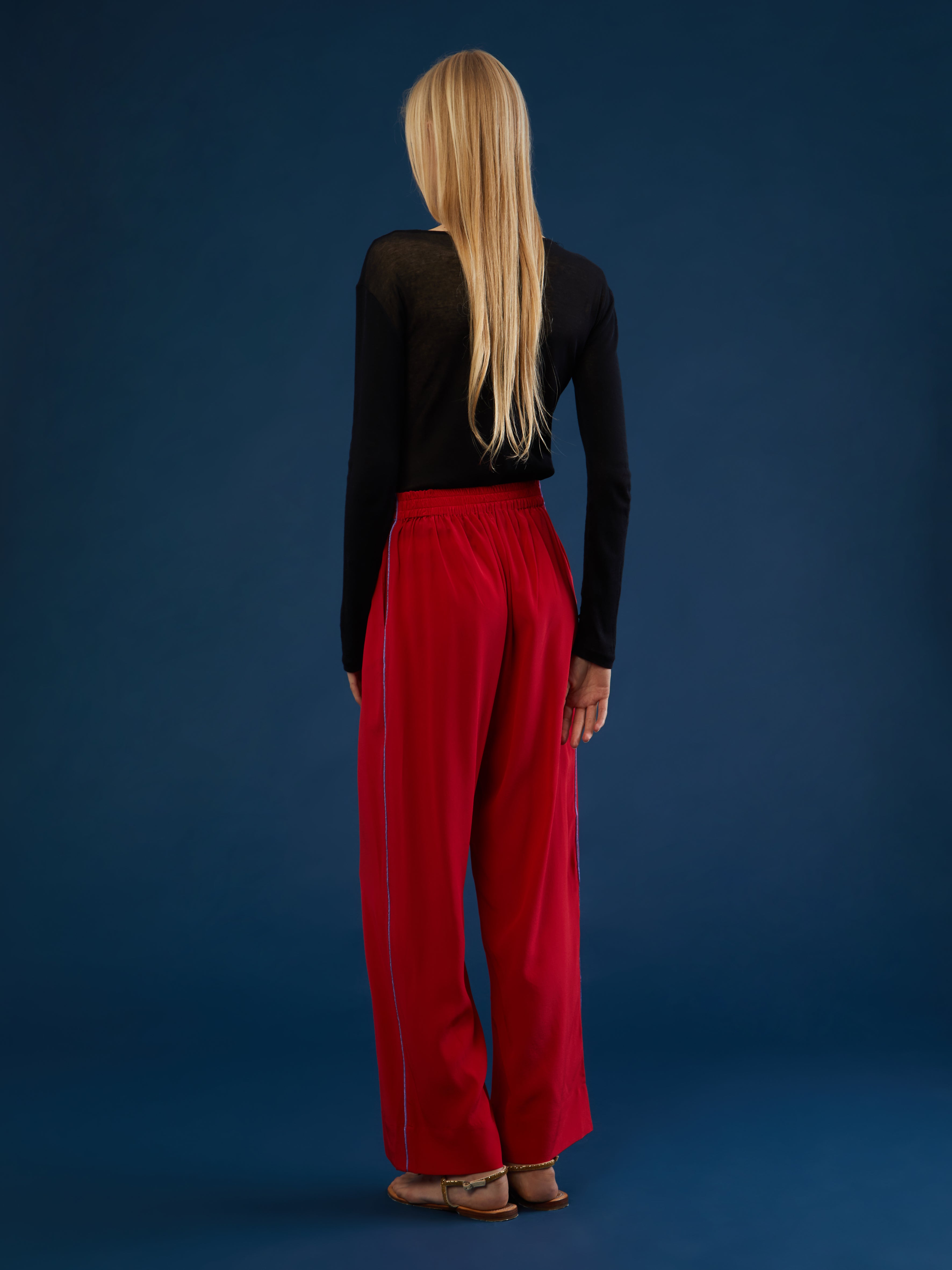 The pants are part of a chic and lightweight silk set crafted in Morocco featuring exquisite Italian silk fabrics. Designed for ultimate comfort and style, this set exudes effortless elegance with its relaxed fit. Each piece is meticulously detailed with Moroccan embroidery, adding a touch of artisanal craftsmanship to the ensemble. The wide-legs offer style and comfort, and its elasticated waist ensures an adjustable fit. DETAILS AND CARE Red with purple details 100% silk Elasticated waist Dry clean only M