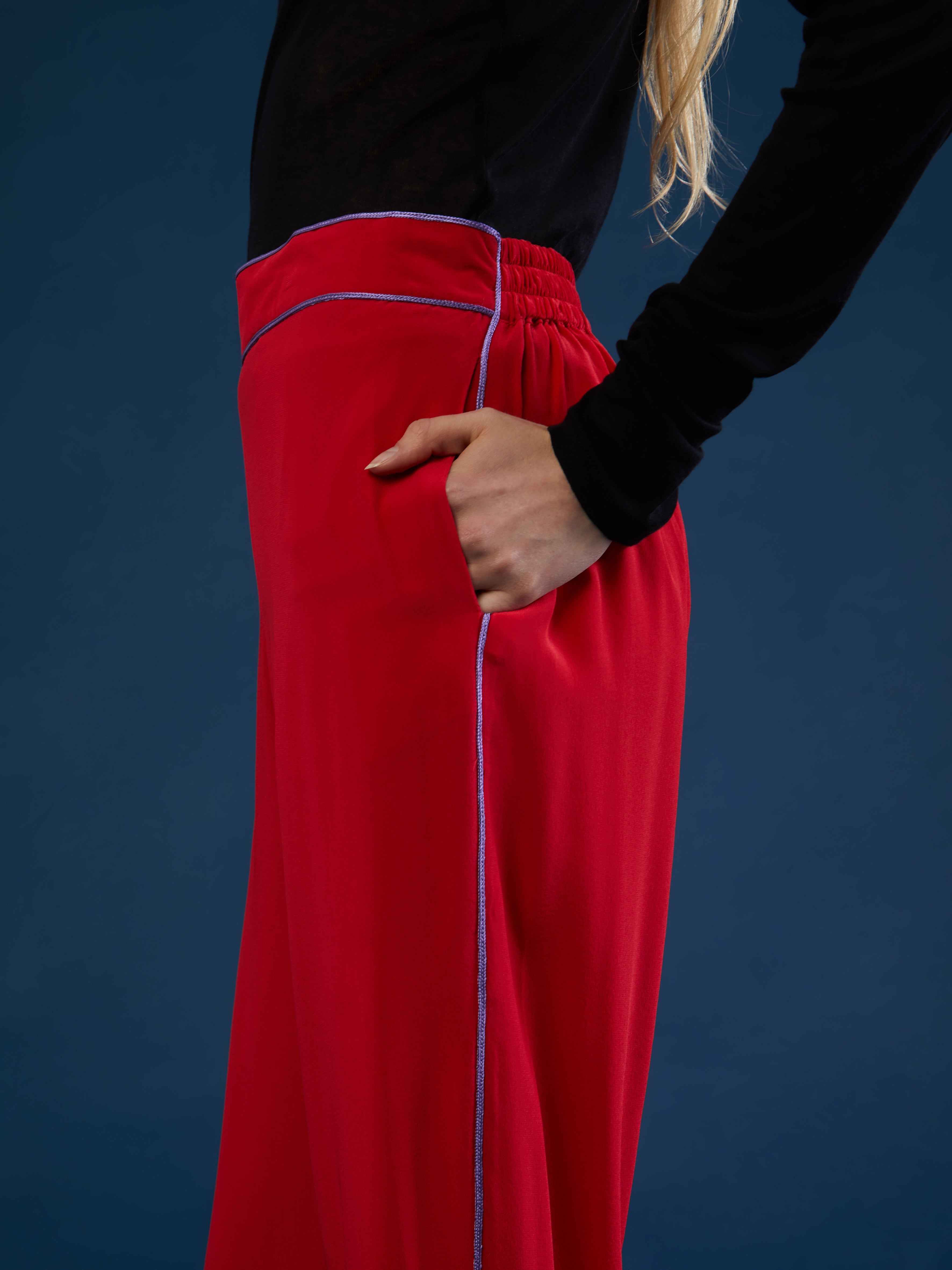 The pants are part of a chic and lightweight silk set crafted in Morocco featuring exquisite Italian silk fabrics. Designed for ultimate comfort and style, this set exudes effortless elegance with its relaxed fit. Each piece is meticulously detailed with Moroccan embroidery, adding a touch of artisanal craftsmanship to the ensemble. The wide-legs offer style and comfort, and its elasticated waist ensures an adjustable fit. DETAILS AND CARE Red with purple details 100% silk Elasticated waist Dry clean only M