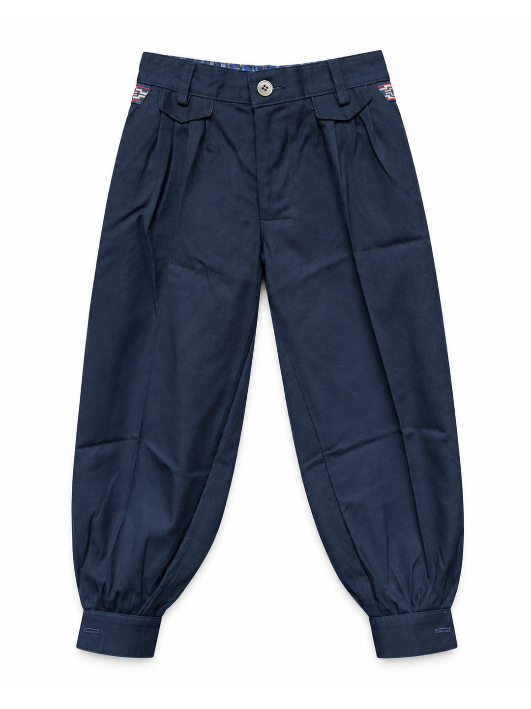 A pair of navy blue pleated trousers with a button closure and elasticized cuffs, shown flat against a white background. Argentine Bombacha Pants, horseback riding, traditional gaucho, Argentine cowboy attire. Soft and breathable fabrics, perfect pants for all-day wear. With a loose fit and elasticated waistband, they allow for plenty of movement, while the high waist provides extra coverage. Everyday look, perfect for both urban and countryside adventures. Cotton Corduroy, KIDS, PANTS, KIDSWEAR, BOTTOM, KI
